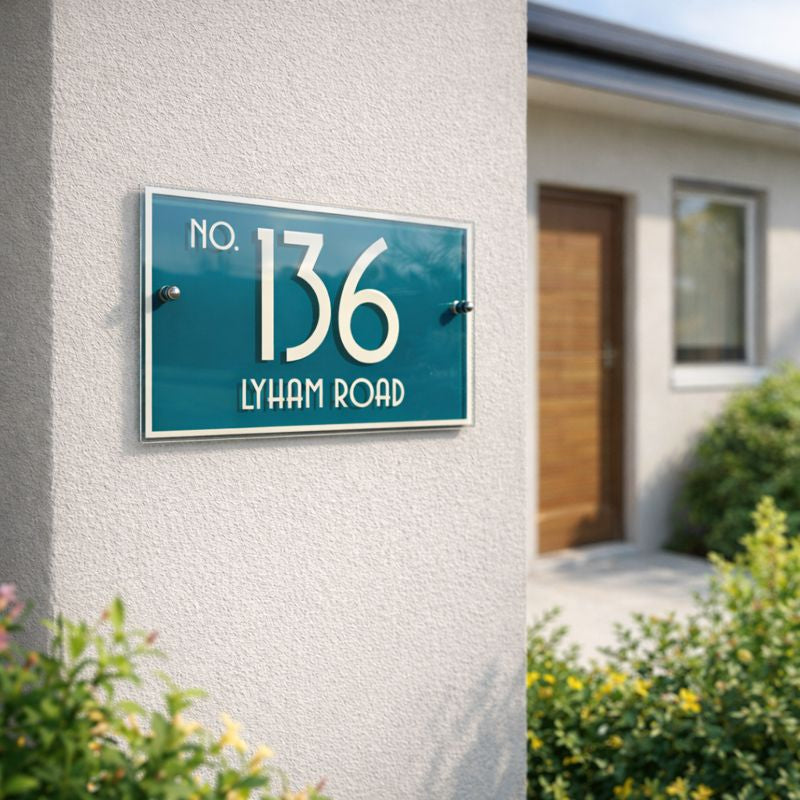 Urban 6 House number sign, landscape style, on a wall with a blurred house background