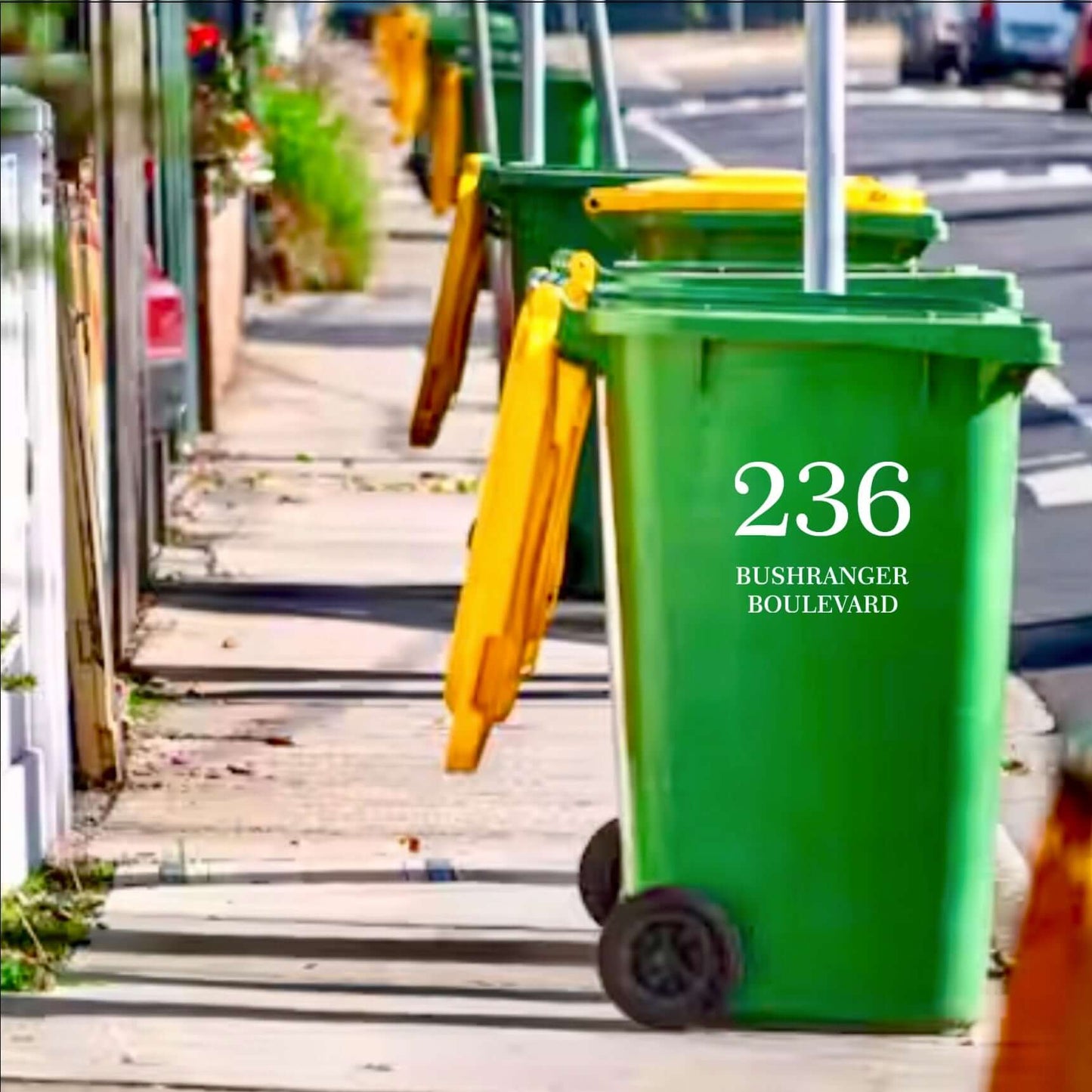 Green bin on sidewalk with '236 Bushranger Boulevard' decal, showcasing premium bin decals for enhanced curb appeal and easy identification.