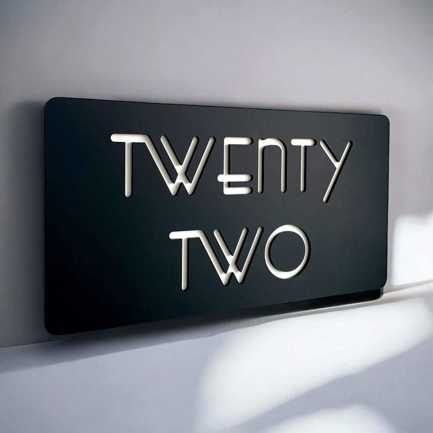 Modern SW2 house number sign displaying "Twenty Two" with backlit design made in Australia, ideal for contemporary exterior displays.