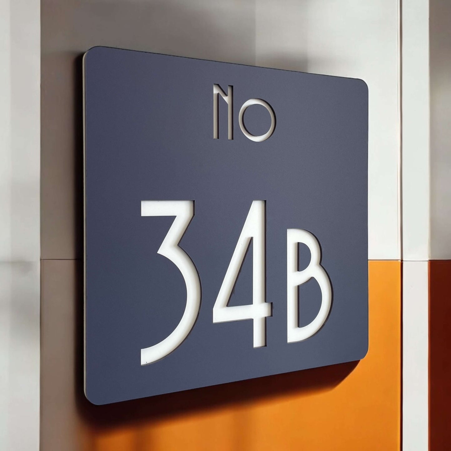 SW2 house number sign mounted on wall, displaying 'No 34B', Australian made, dark finish, easy DIY peel-and-stick installation option.