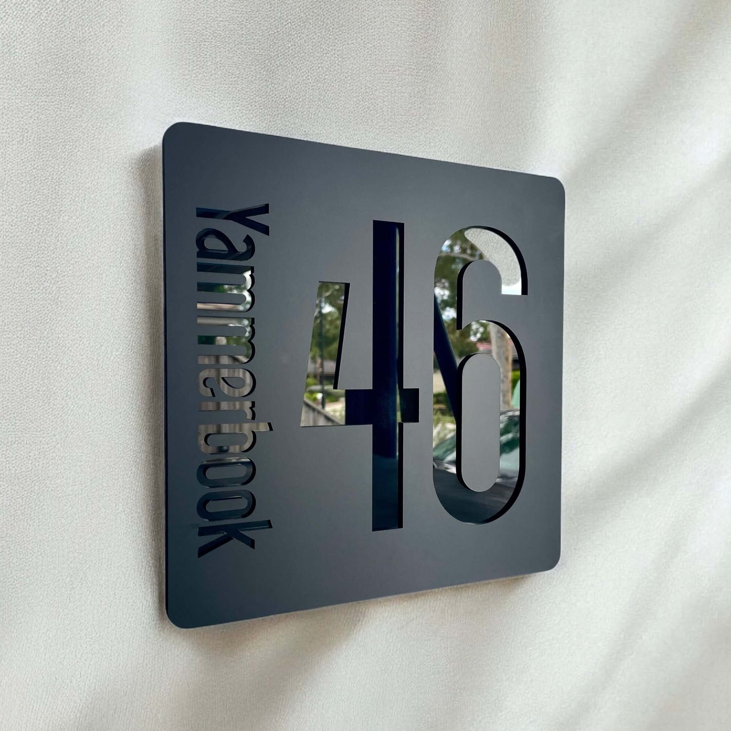 Modern SW2 house number sign, black Prisma 3 design, 230mm square, easy DIY install, weather-resistant for flat surfaces.