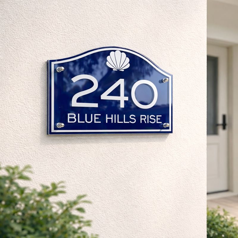 Heritage Petite compact house number sign in blue with white numerals 240 and street name Blue Hills Rise mounted on a light rendered wall