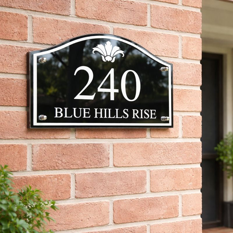 Heritage Petite compact house number sign in black with white numerals 240 and street name Blue Hills Rise mounted on a red brick wall