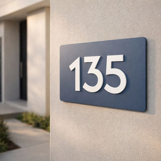 Legacy L3 3D rectangular house sign in Stormy Grey acrylic with raised lettering spelling "135" mounted on a light grey rendered wall