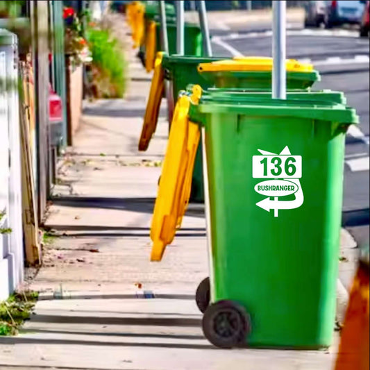 Green bin with Bushranger bin decal by SW2, enhancing street appeal on a sunny sidewalk.
