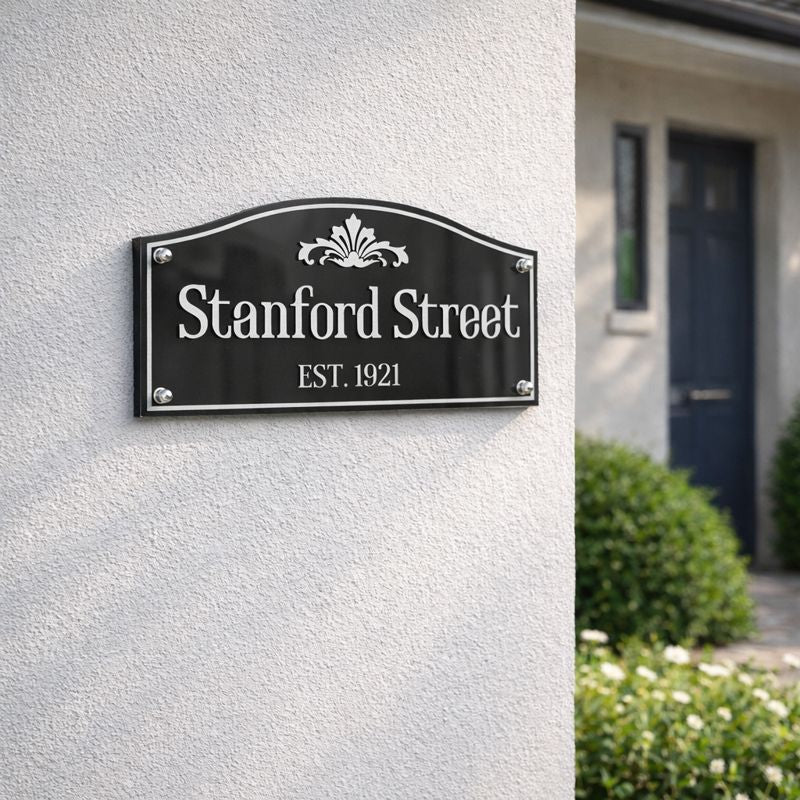 Heritage style house name plate with 'Stanford Street EST. 1921' on a light gray wall.