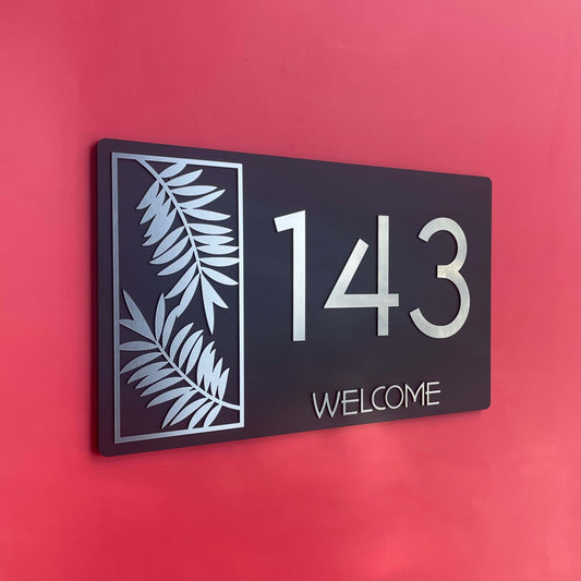 House number sign 143 with fern design, Lustre L2, SW2, Australian made, weather-resistant, on red wall.