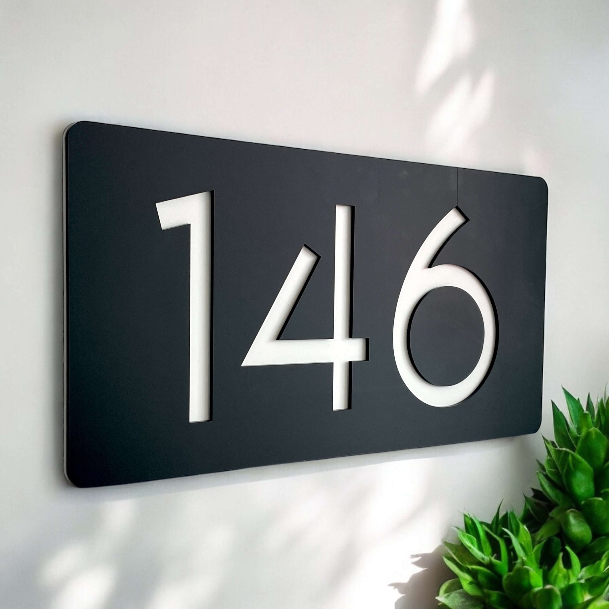 SW2 house number sign, Australian made, featuring numbers 146 on a black rectangular plaque, ideal for homes, easy DIY installation.