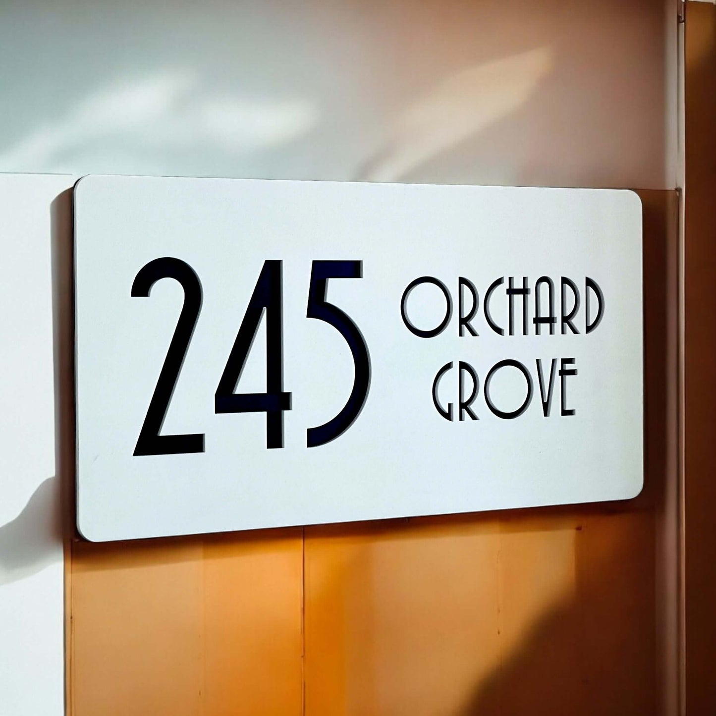 Nouveau 5 SW2 house number sign displaying '245 Orchard Grove' on a modern white background.