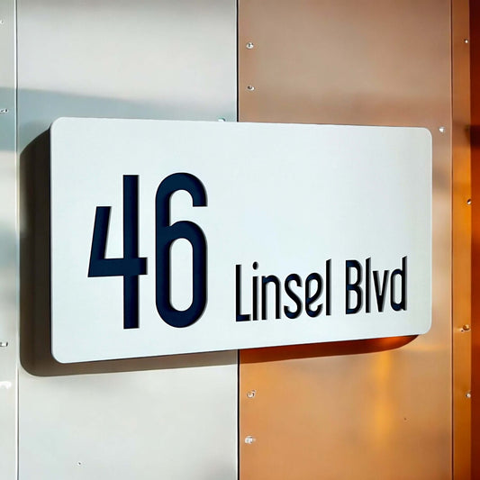 Modern white house number sign with '46 Linsel Blvd' in black text, mounted on a metallic background. Ideal for Australian homes. SW2 model.