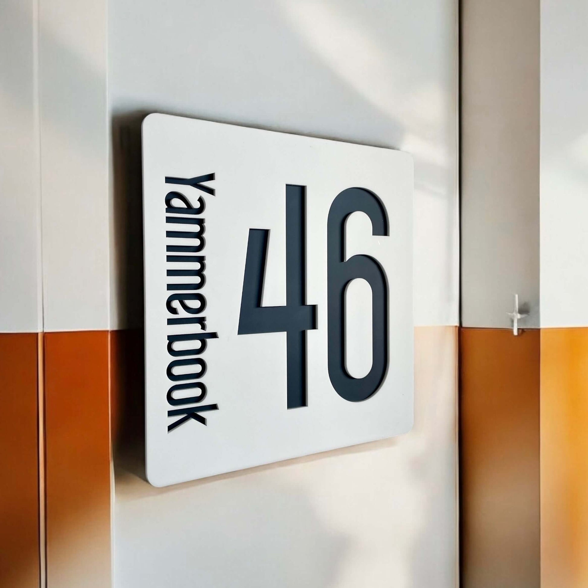 "SW2 house number sign, Australian made, featuring 'Yammerbook' and '46' in black on a 230mm square panel with easy DIY installation."