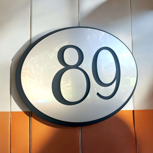 Oval house number sign '89' with floating mount, black acrylic and silver design, Australian made, ideal for modern home exteriors.