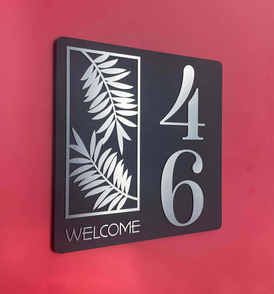 Black house number sign with silver fern design, displaying numbers 4 and 6, titled 'Welcome' on a red background, Australian made.