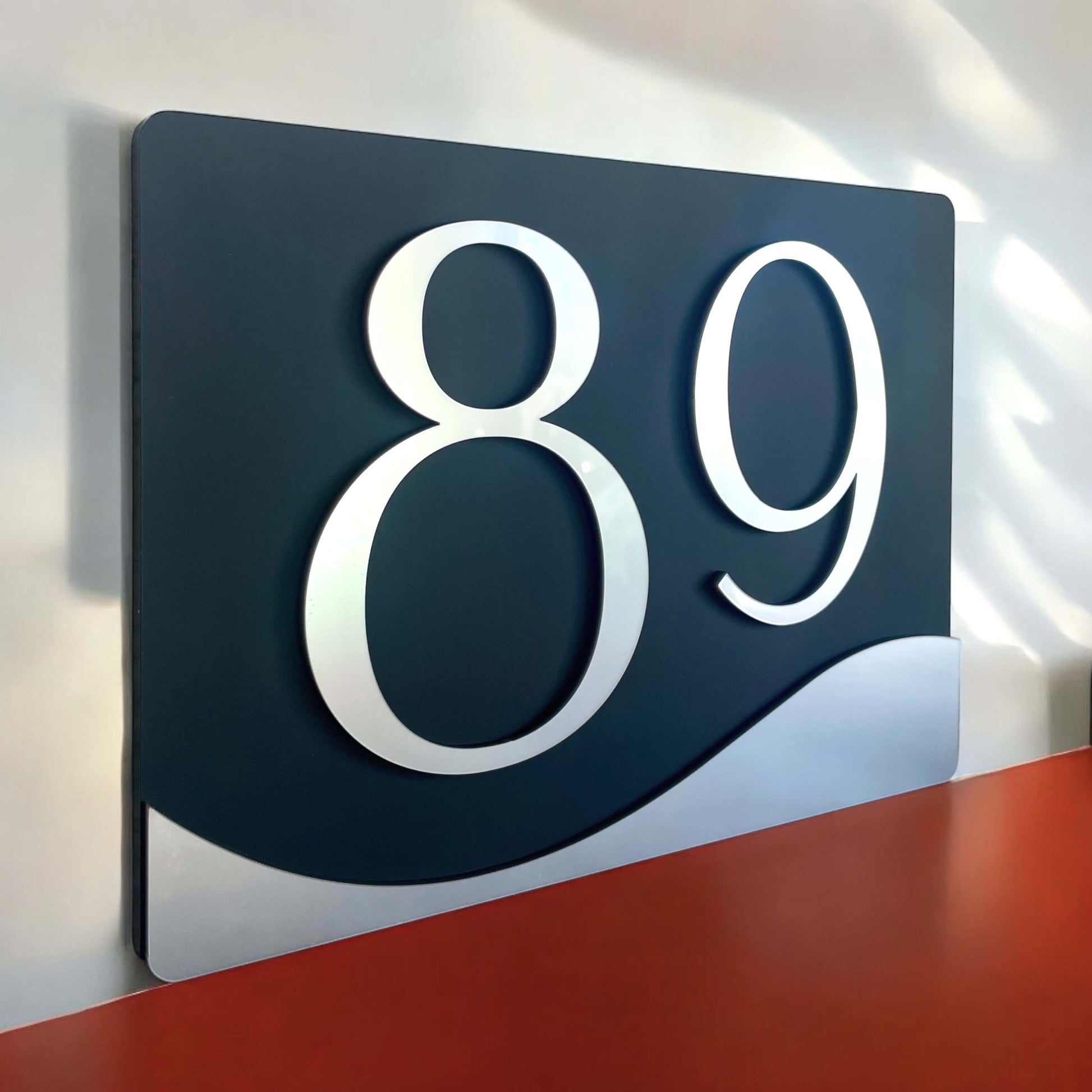 House number sign 89 with floating mount, matte black and silver, made in Australia, SW2 style, showcasing bold modern design.