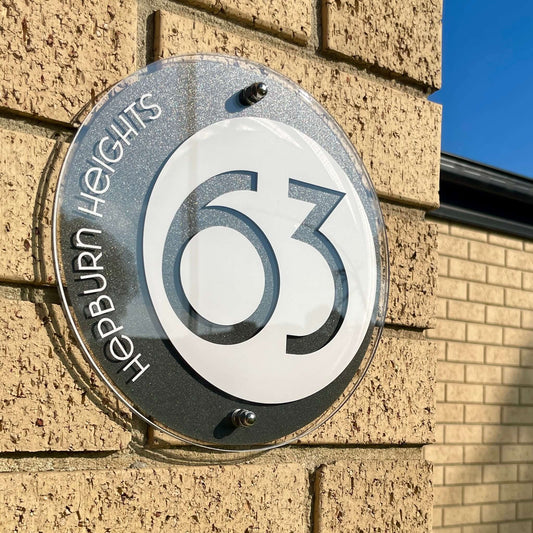 SW2 house number sign mounted on brick wall, Australian made, Vogue 5 design, 230mm diameter, easy DIY installation option.