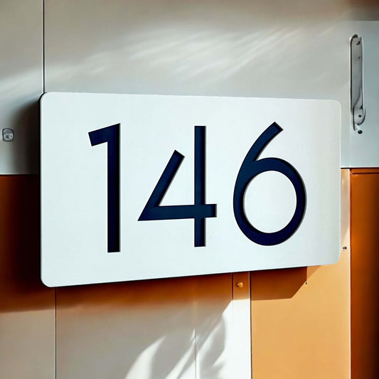 Modern SW2 house number sign displaying '146', mounted on a smooth, flat wall, suitable for DIY installation.