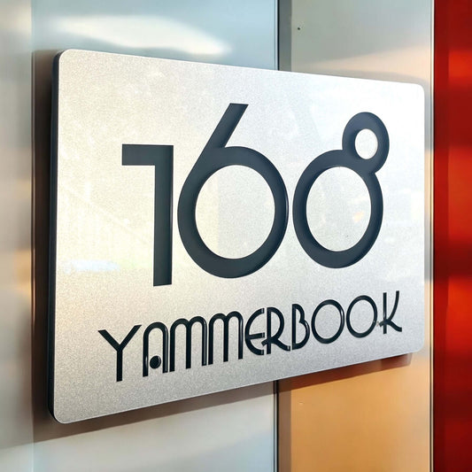 Elegant silver and black house number sign '1608' on a door, floating mount design with bold standoff. Ideal for modern exteriors.
