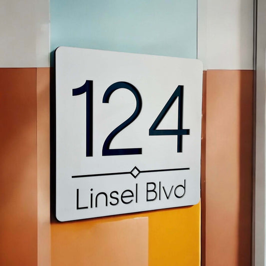 Modern house number sign with '124 Linsel Blvd', sleek design on a colorful background.