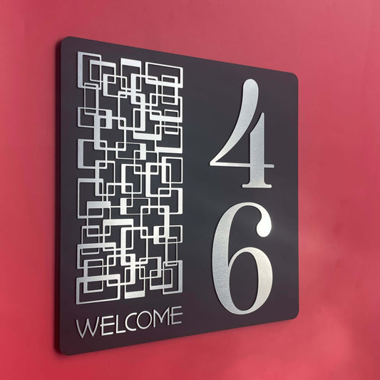 Modern house number sign with number 46 and "Welcome" in silver on black background, ideal for SW2 locations, weather-resistant.